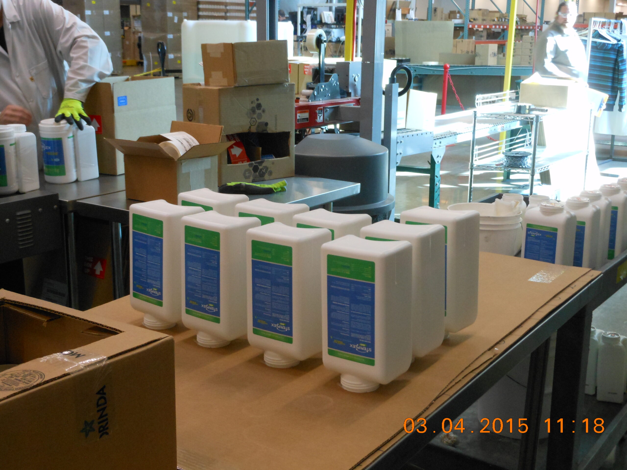 pesticide product bottles on a workstation in a factory setting