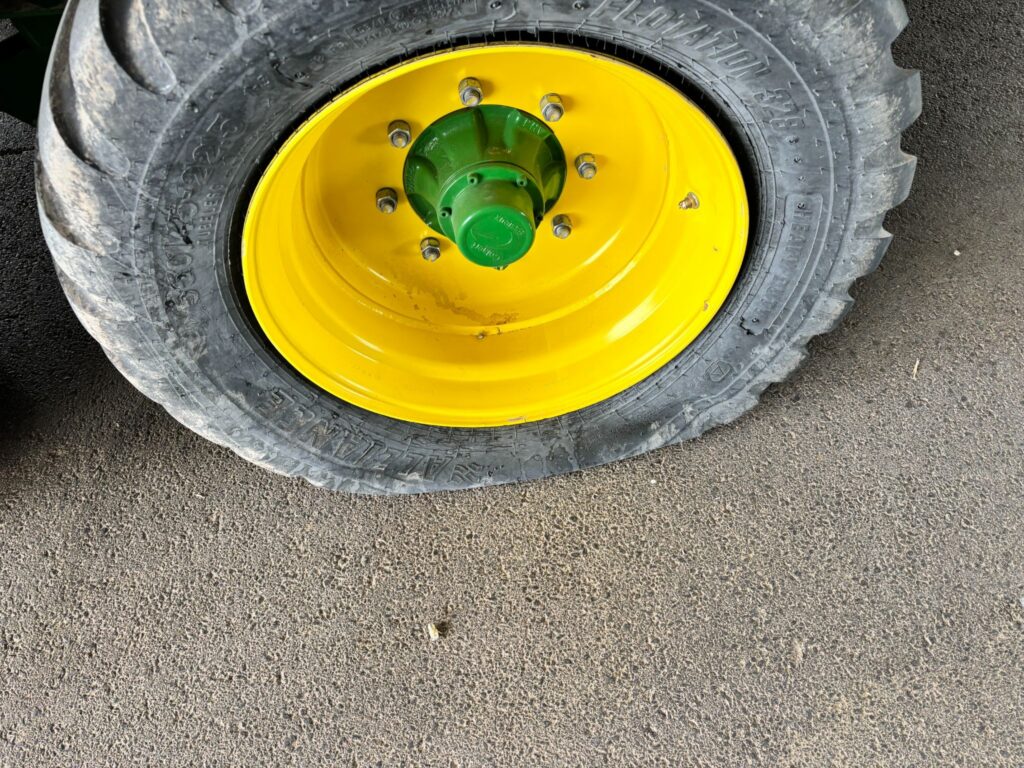 Hay equipment that has been vandalized and has a flat tire