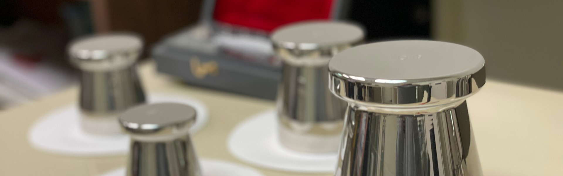 various large metal weights on small white circles